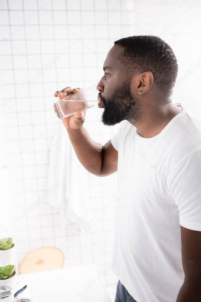 side view of afro-american man drinking water 