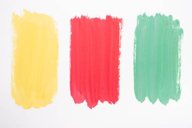 top view of abstract colorful green, yellow and red paint brushstrokes on white background clipart
