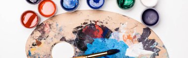 top view of palette with Gouache paints and paintbrush on white background, panoramic shot clipart