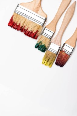 top view of dirty paintbrushes on white background clipart