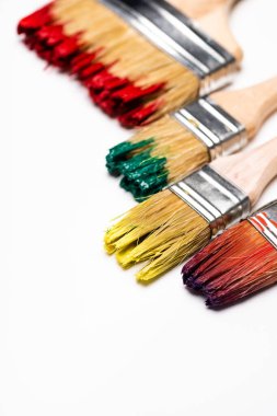 close up view of dirty paintbrushes on white background clipart