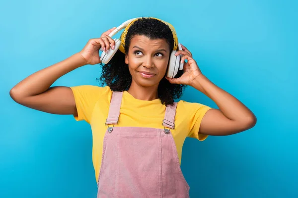 Zdezorientowana Afroamerykanka Słuchawkach Bezprzewodowych Słuchając Muzyki Niebiesko — Zdjęcie stockowe