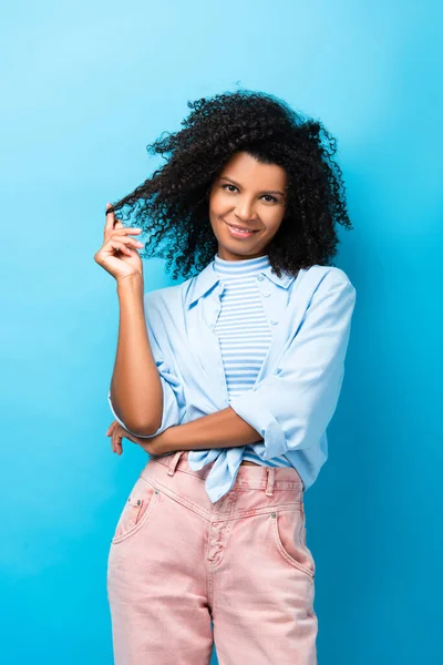 Happy African American Woman Twirling Hair Finger Blue — Stock Photo, Image