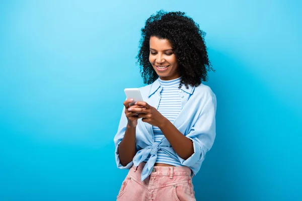 Cheerful African American Woman Texting Smartphone Blue — Stock Photo, Image