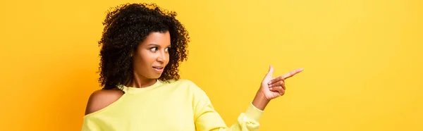 Surprised African American Woman Pointing Finger Yellow Banner — Stock Photo, Image