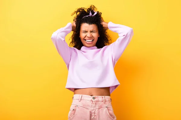 Curly African American Woman Closed Eyes Adjusting Hair Yellow — Stock Photo, Image