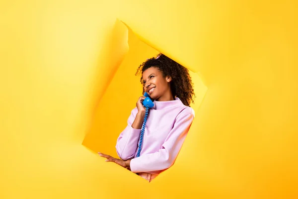 Happy African American Woman Talking Retro Telephone Hole Ripped Paper — Stock Photo, Image