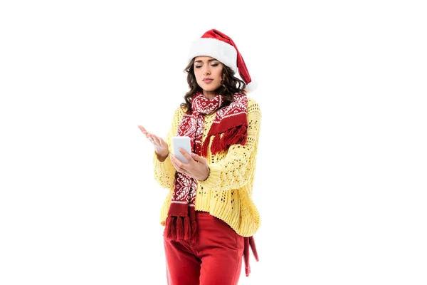 Young Woman Santa Hat Scarf Pointing Hand While Holding Smartphone — Stock Photo, Image