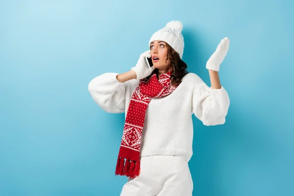 Shocked Young Woman White Winter Outfit Talking Smartphone Gesturing Blue — Stock Photo, Image