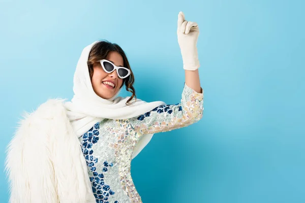 Excited Woman Sunglasses Scarf Gesturing Blue — Stock Photo, Image