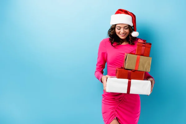 Young Joyful Woman Santa Hat Dress Holding Wrapped Presents Blue — Stock Photo, Image