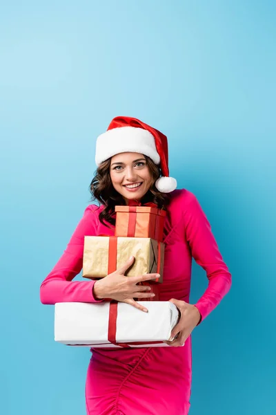 Joyful Woman Santa Hat Dress Holding Wrapped Presents Blue — Stock Photo, Image