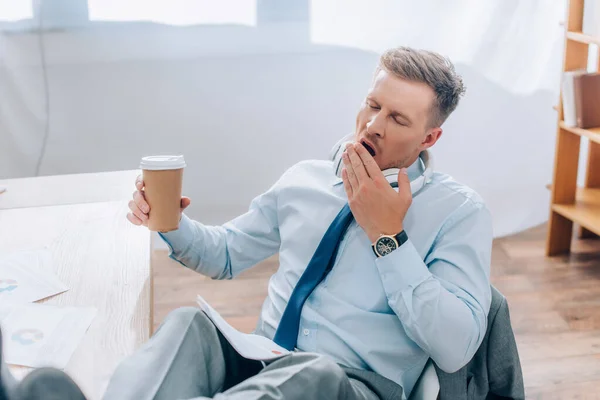 Tired Businessman Yawning While Holding Coffee Papers Blurred Foreground — Stock Photo, Image