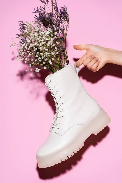 Cropped View Woman Holding White Boot Wildflowers Pink Background — Stock Photo, Image
