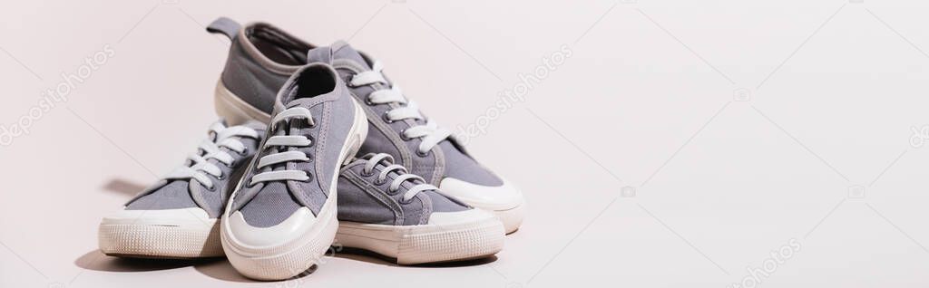 grey casual sneakers on white background, banner