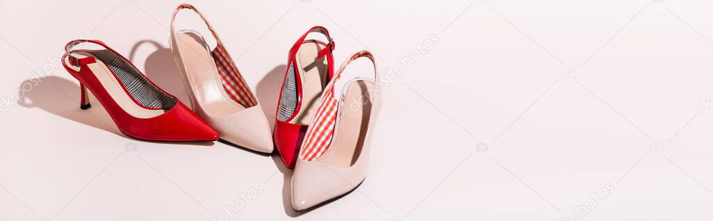 leather heeled shoes on beige background, banner