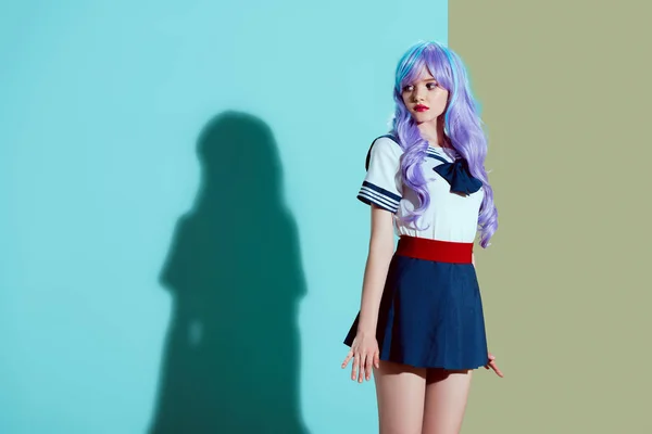 Beautiful girl in bright wig and skirt standing and looking away in studio — Stock Photo