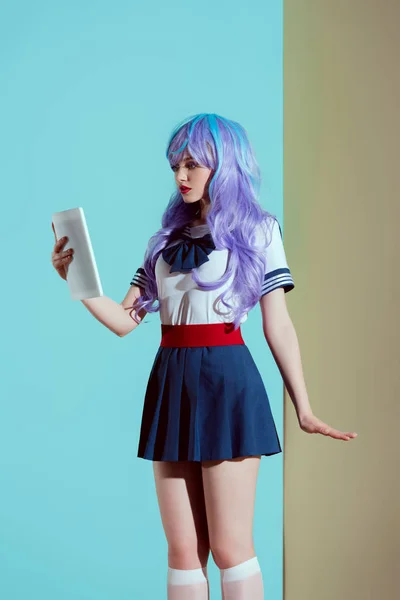 Young woman in bright wig using digital tablet in studio — Stock Photo