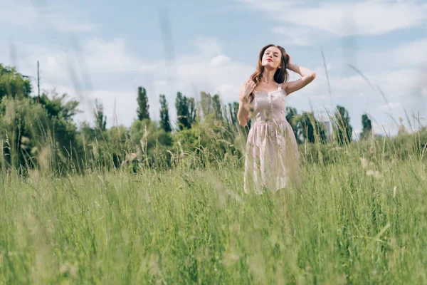 Jeune jolie femme en robe élégante debout dans la prairie seule — Stock Photo