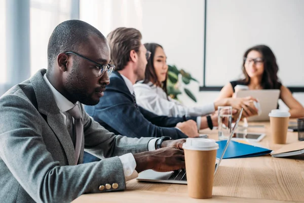 Selective focus of multicultural business people having business meeting in office — Stock Photo