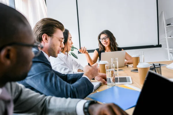 Selective focus of multicultural business people having business meeting in office — Stock Photo