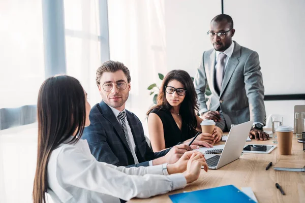 Selective focus of multicultural business people having business meeting in office — Stock Photo