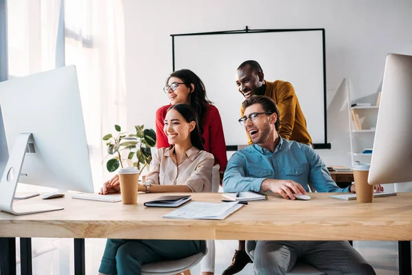 Smiling multiracial business team working on project together in office — Stock Photo