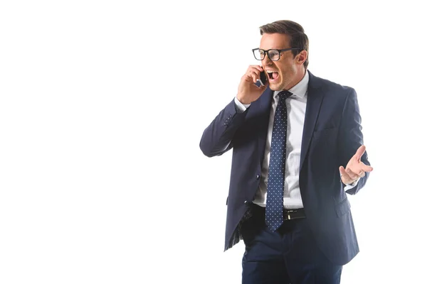 Angry screaming businessman in eyeglasses talking on smartphone isolated on white background — Stock Photo