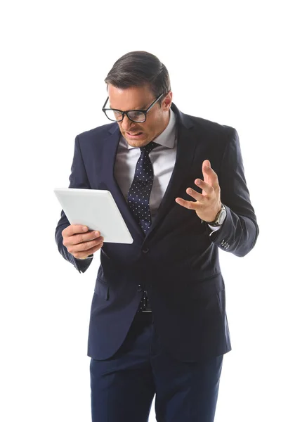 Wütender Geschäftsmann mit Brille gestikuliert mit der Hand und blickt auf digitalen Tablet-Bildschirm auf weißem Hintergrund — Stockfoto