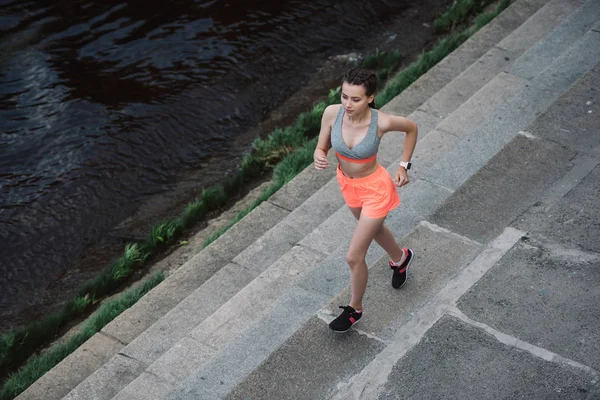 Vista aérea de una joven corredora corriendo por la ciudad - foto de stock