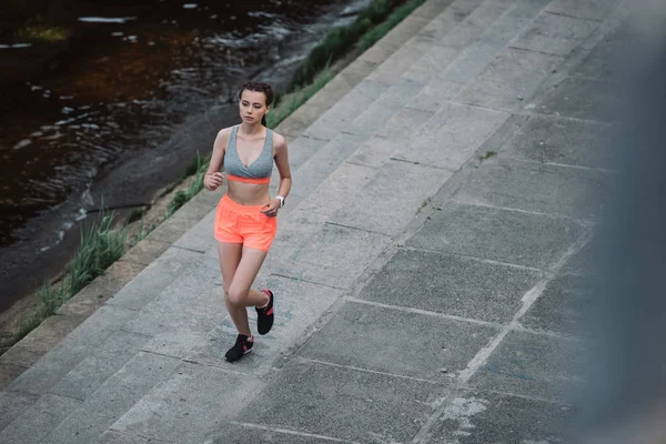 Joven atlética corriendo en muelle - foto de stock