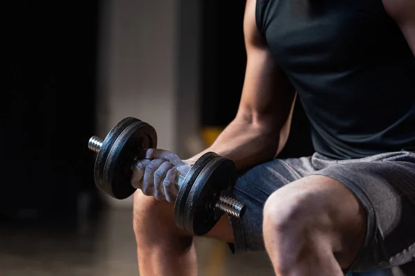 Cropped shot of muscular african american man training with dumbbell — Stock Photo