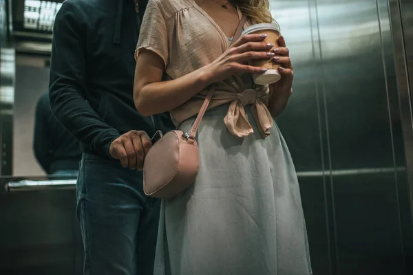 Cropped view of robbery pickpocketing smartphone from womans bag in elevator — Stock Photo