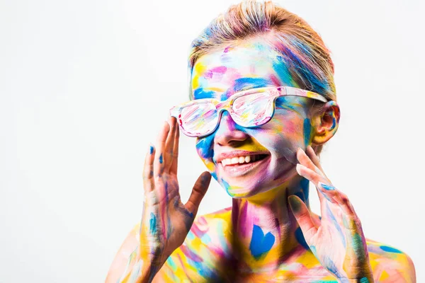 Smiling attractive girl with colorful bright body art and sunglasses isolated on white — Stock Photo