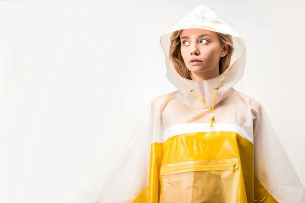 Beautiful woman in yellow and white raincoat looking away isolated on white — Stock Photo