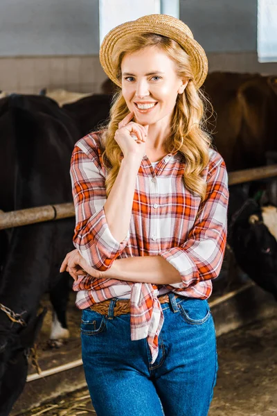 Retrato de agricultor atraente em chapéu de palha olhando para a câmera no estábulo — Fotografia de Stock