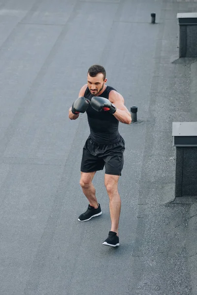 High angle view of handsome boxer training on roof — Stock Photo