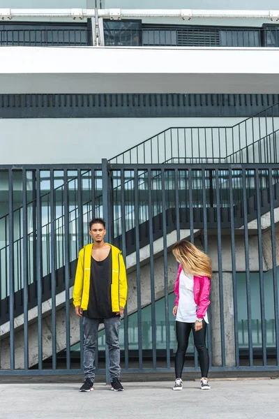 Young stylish couple dancing at urban street — Stock Photo