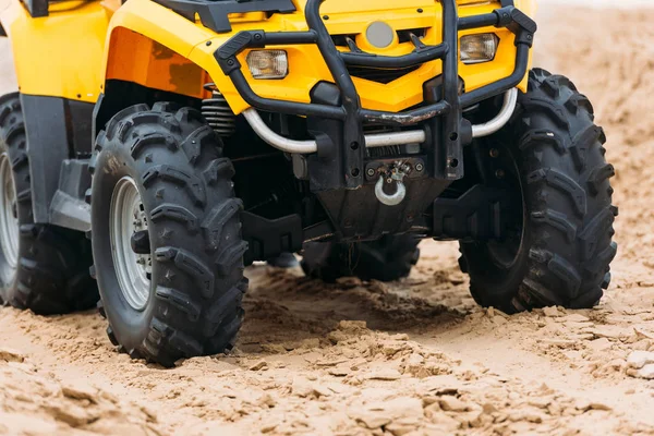 Partial view of all-terrain vehicle on sand — Stock Photo