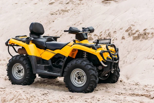 Modern yellow all-terrain vehicle on sand — Stock Photo