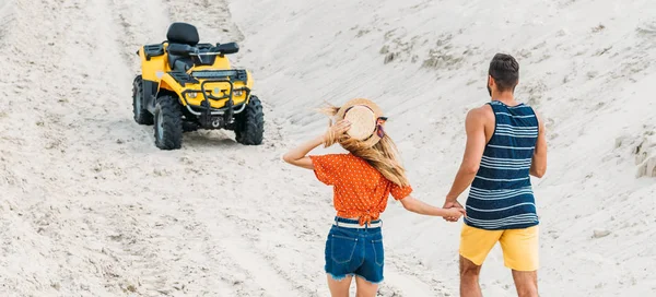 Вид сзади молодая пара собирается ATV по песчаной дороге — стоковое фото