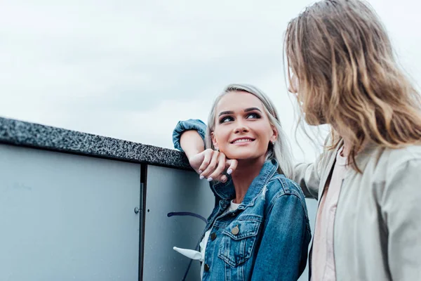 Beautiful young couple flirting on city street — Stock Photo