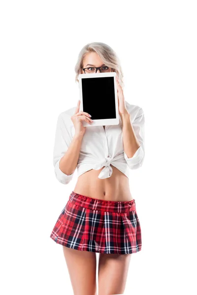 Obscured view of seductive schoolgirl in short plaid skirt holding digital tablet with blank screen isolated on white — Stock Photo