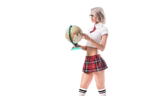 Sexy blond woman in eyeglasses and college uniform holding globe isolated on white — Stock Photo