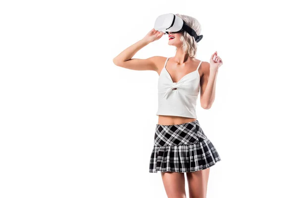 Portrait of sexy schoolgirl in short plaid skirt in virtual reality headset isolated on white — Stock Photo