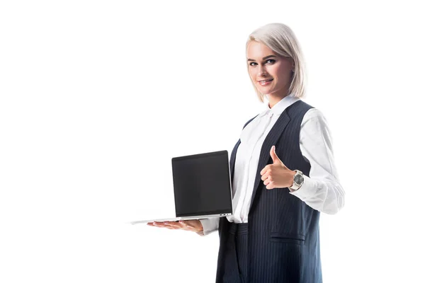 Portrait of businesswoman holding laptop with blank screen and showing thumb up isolated on white — Stock Photo