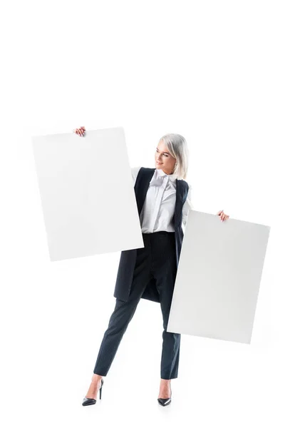 Young businesswoman holding empty banners isolated on white — Stock Photo