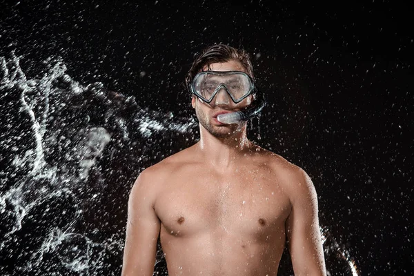 Portrait of shirtless man in swimming mask with snorkel swilled with water isolated on black — Stock Photo