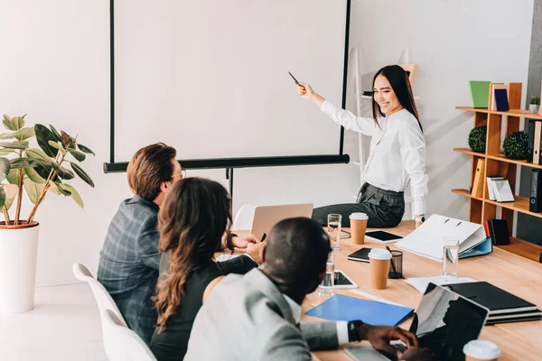 Partial view of multiethnic business team having business meeting together in office — Stock Photo