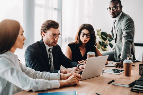 Selective focus of multicultural business people having business meeting in office — Stock Photo